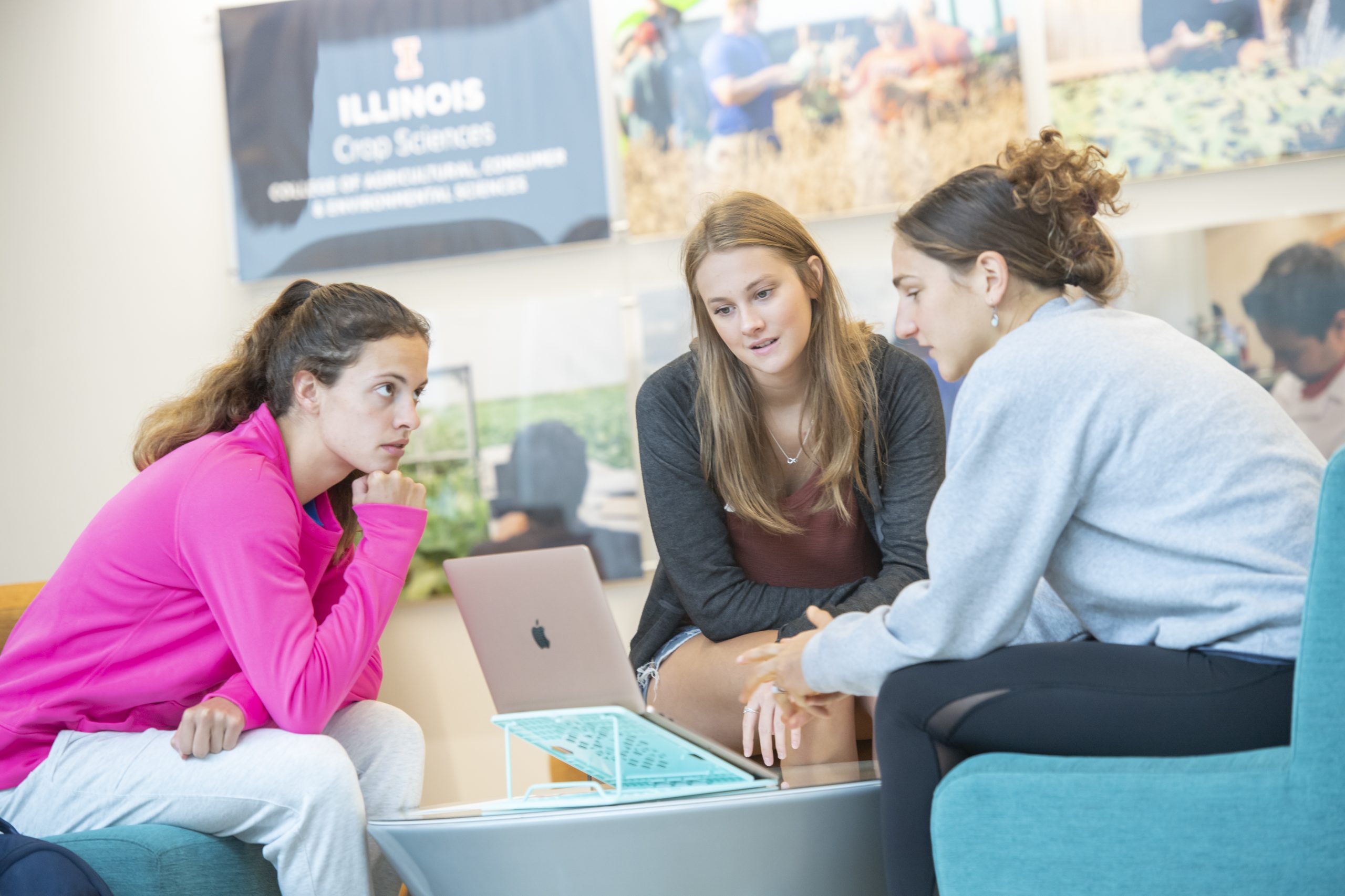 Students working in a group around a computer