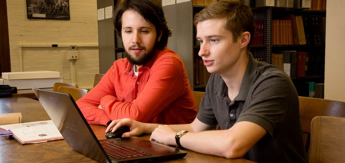Two people working on computer