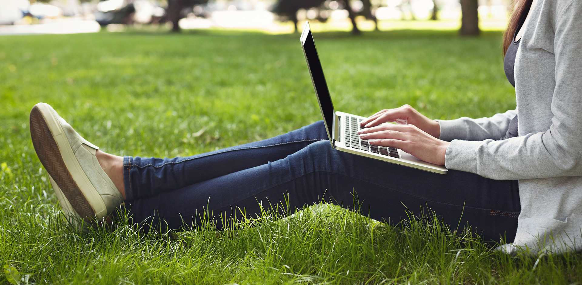 woman on laptop in park