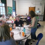 Carolyn discusses the curriculum materials with a teacher.