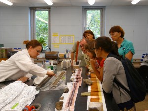 Melissa describes a sediment core to teachers during a lab tour.