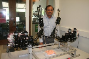 Dr. Kasavadas stands with a tele-surgery robot