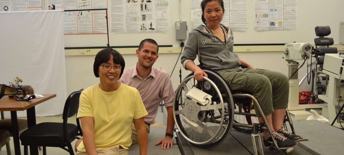 photo of professor hsiao-wecksler with student and person in a wheelchair