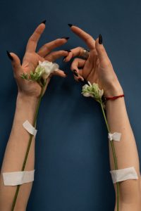 Photo of woman's arms with flowers representing veins on arms