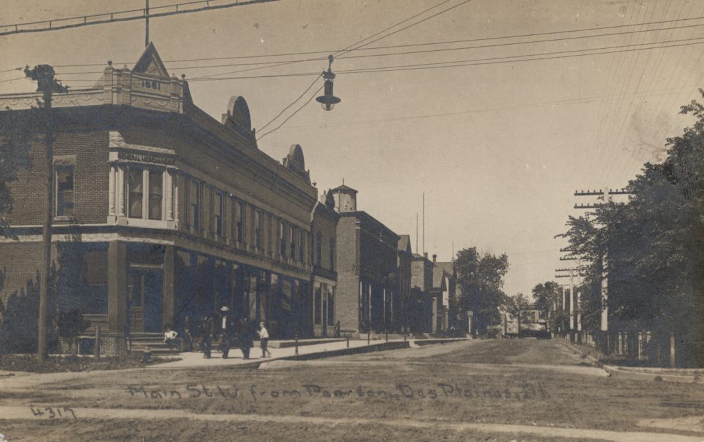 Postcard image of storefronts on historic Main Street in Des Plaines, Illinois.