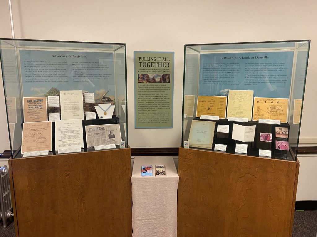 Two exhibit cases containing items on display in "Pulling It All Together."