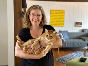 Photo of Dr. Kate McDowell holder her cat, Xylo