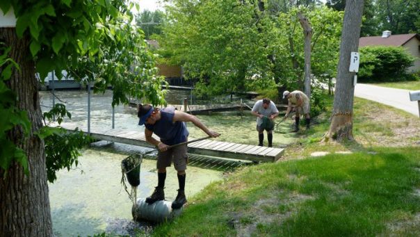 several people dip netting in the Fox River drainage