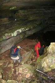 two people look for snails in a cave
