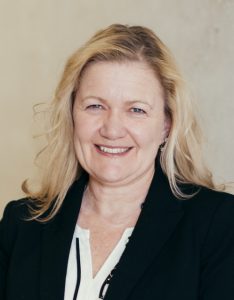 Photo of middle aged blond woman in business attire