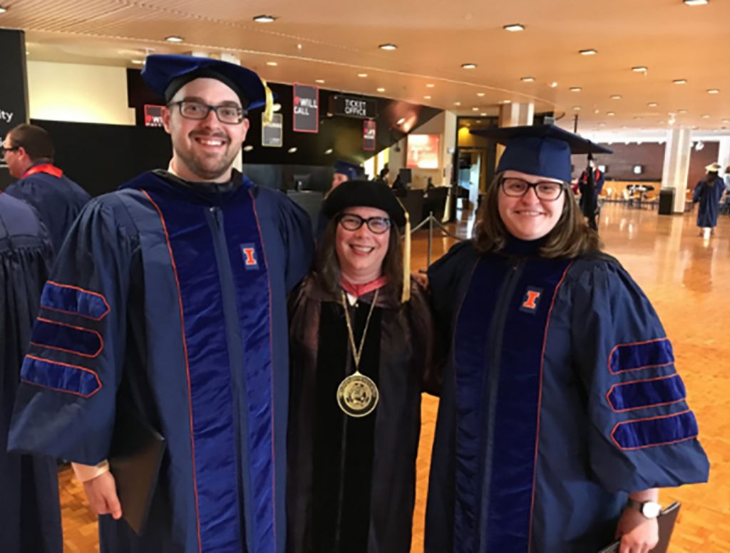 Josh and Jordan with Cathy at their Ph.D. graduation in regalia. (2018)