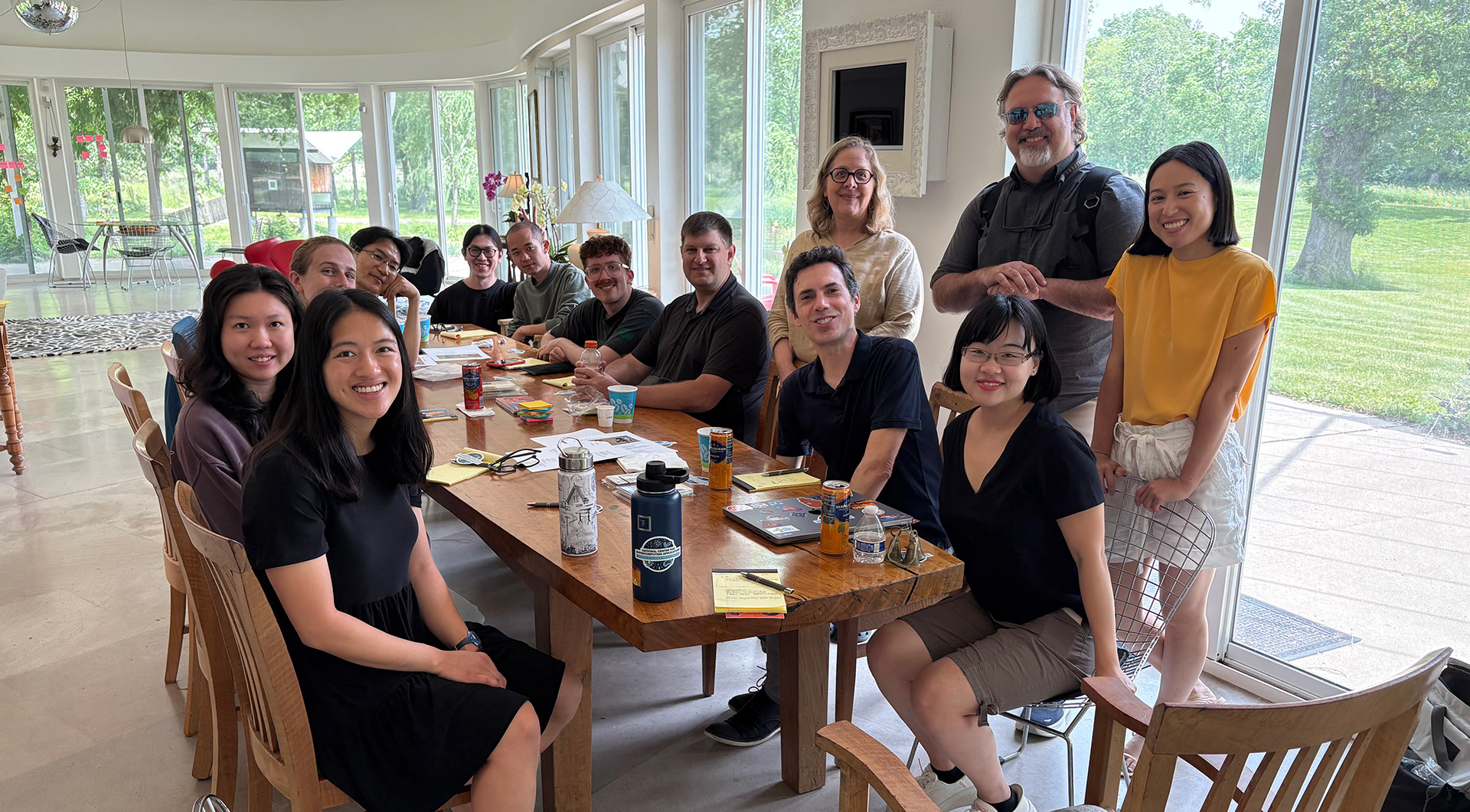 The NCSA UI UX team is seated at a table and looking toward the camera.
