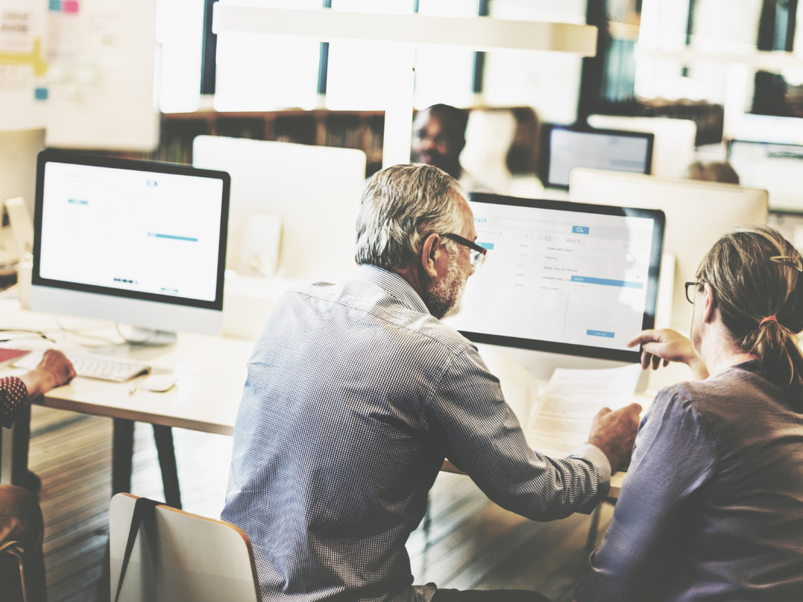 Group of diverse senior adults in computer class