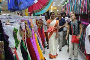 Photo 2: A store employee attends to a student shopping during the 2014 India study tour. Credit: ADMI/K.Wozniak