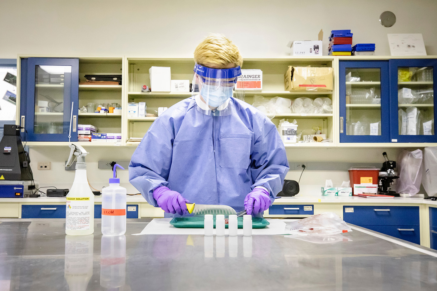 Person working in lab with lab protective gown