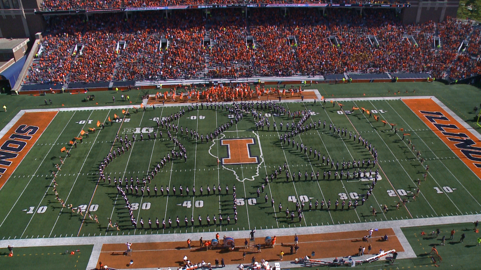 Marching Illini form recycling symbol