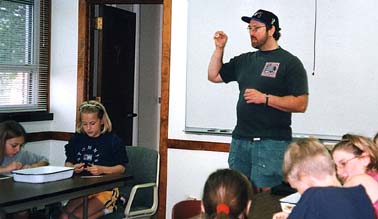 Mark Metz speaks to several students in a classroom