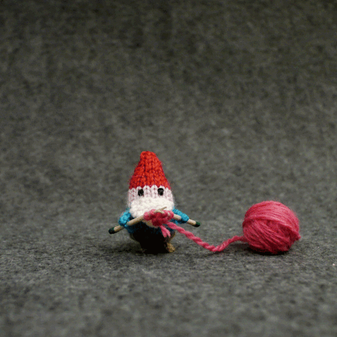 A gif of a yarn gnome sewing a yarn heart