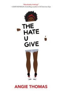 african american girl holds sign that reads the hate u give