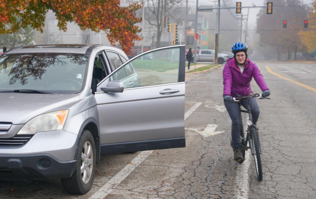 biker avoiding an open car door