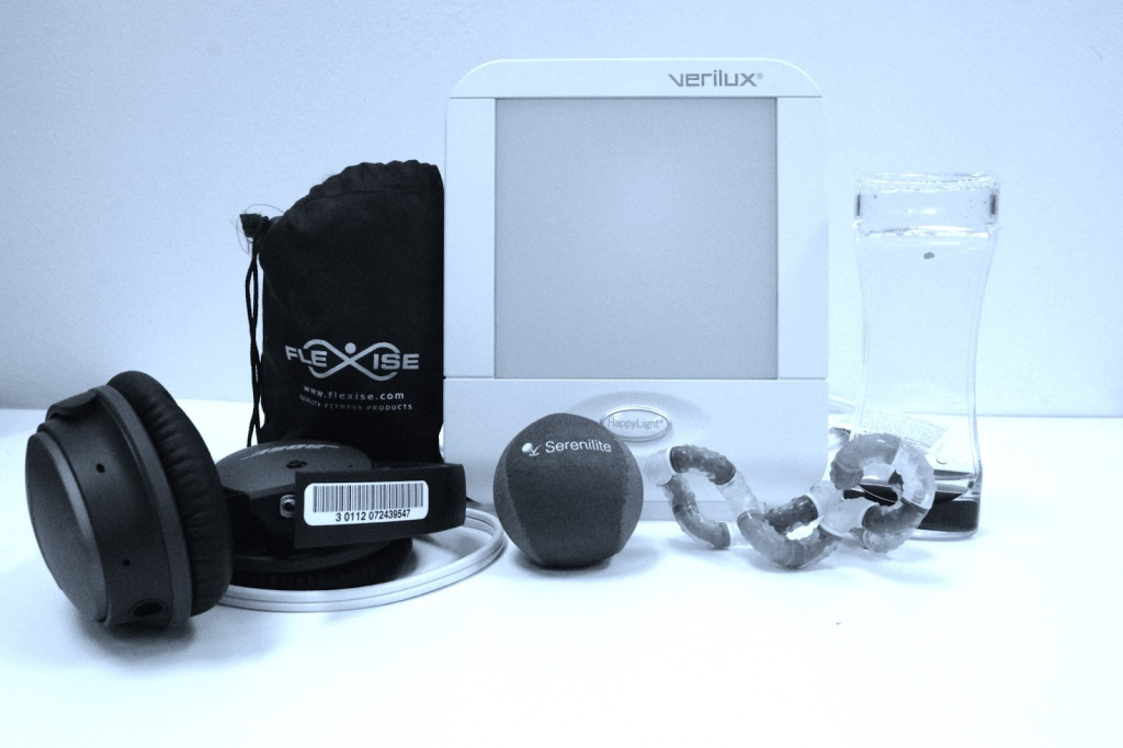 tranquility kit showing happy light, stress ball, fidget toys and headphones