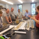 Melissa (far right) demonstrates to teachers how sediment cores are used in climate science.