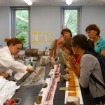 Melissa describes a sediment core to teachers during a lab tour.