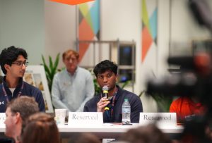 Shrikar Lekkala talking amongst a panel of people