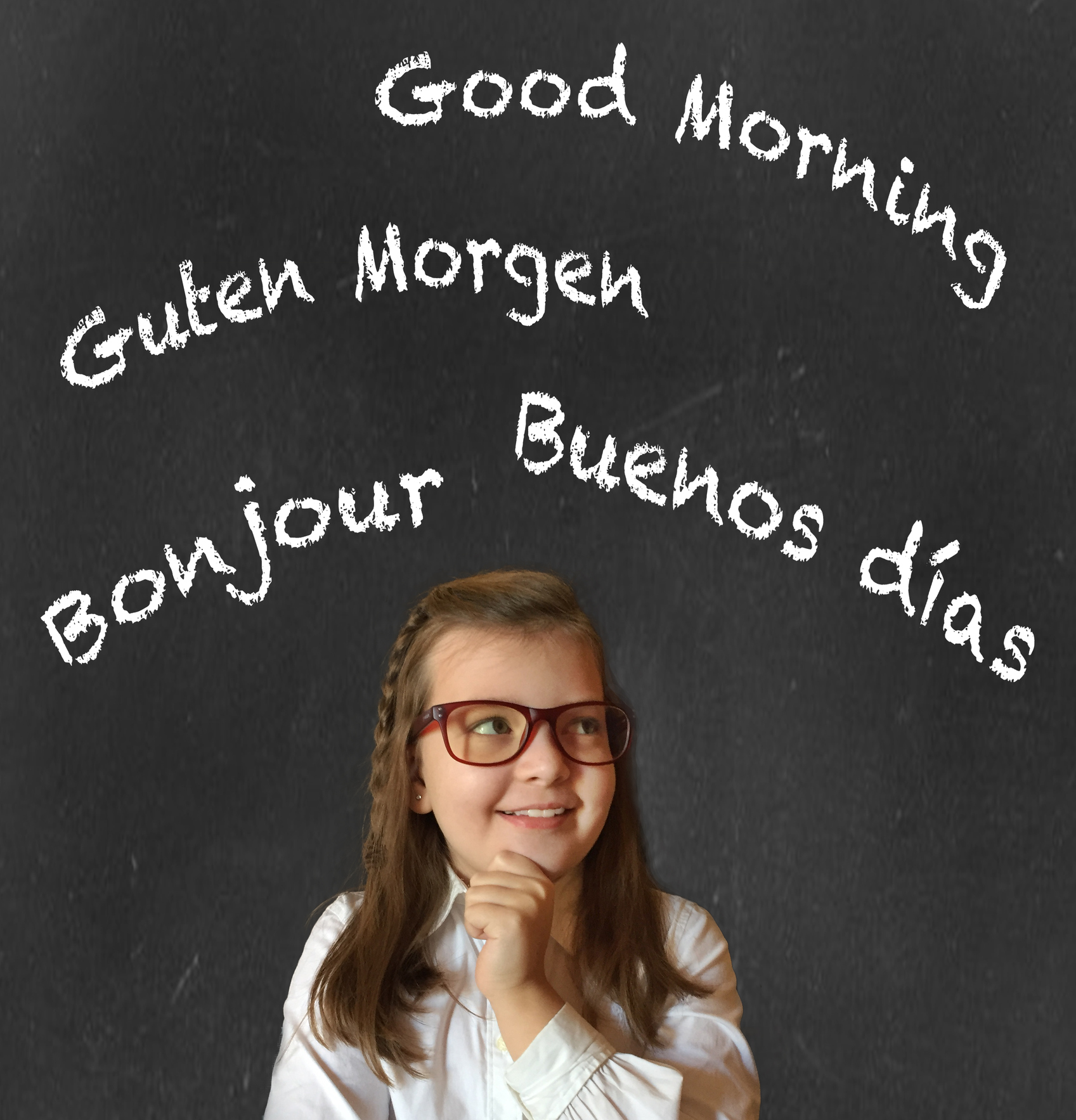Cute little girl in elementary school thinking of all the languages she wants to learn and speak. Blackboard background. Multilingual and bilingual concept.