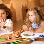 children drawing with colored pencils