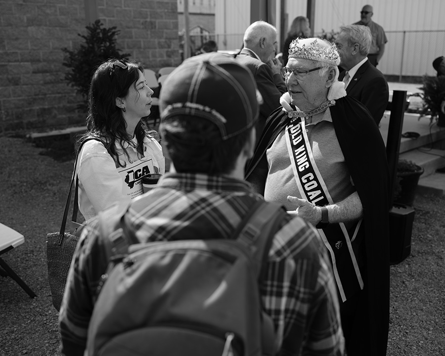 Jordan Woodward (left) talking to Old King Coal 2025, John Smith (right). Johnathan Hettinger, communications director of the Climate Jobs Institute, is in the center of the frame.