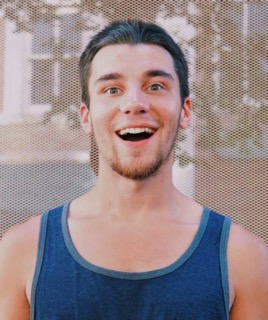 Adam, a man with short brown hair, smiles.