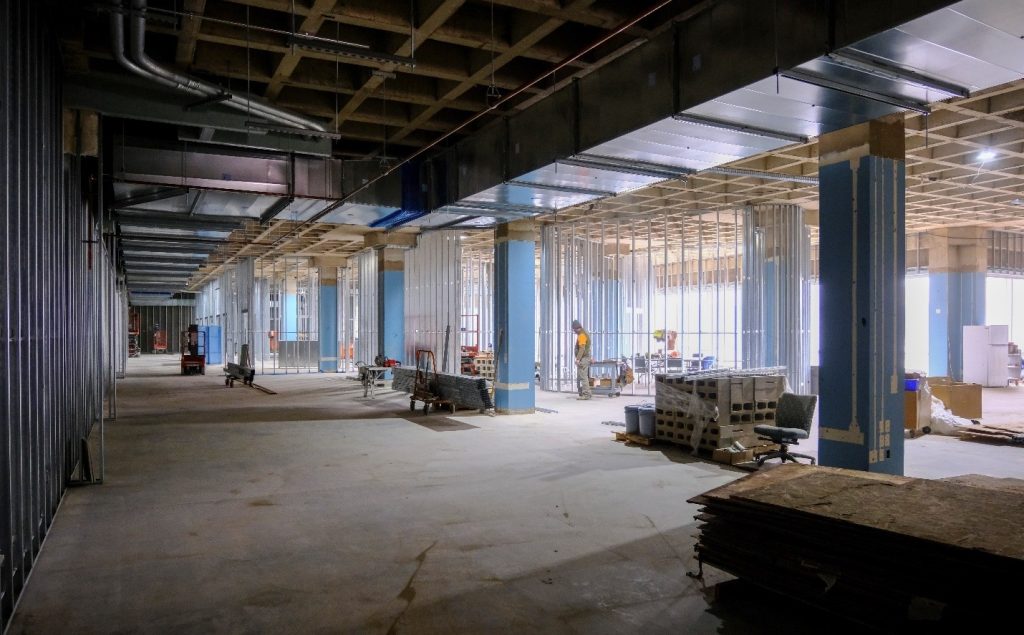 Ductwork and electrical conduit being installed above instructional rooms.