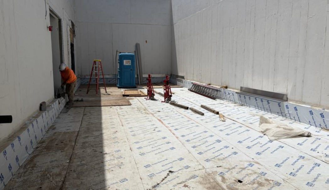 Thru-wall flashing being installed at south area well