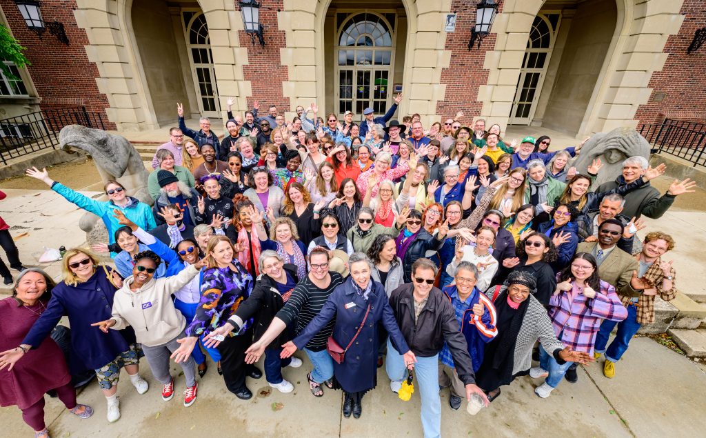 The Library staff at the University of Illinois gather for a time-capsule group shot outside the entrance to the main library.