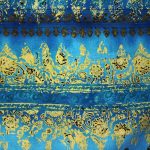 A closeup of blue and gold fabric