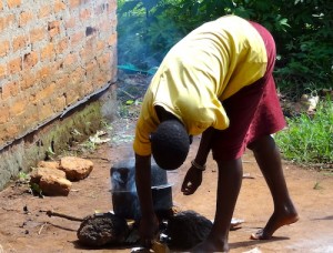 An African man boiling water.