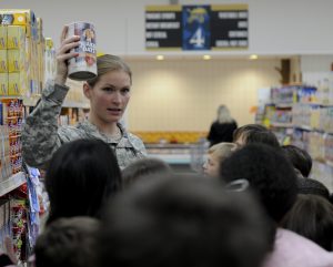 HEIDLBERG, Germany - Cpt. Rachel Morgans, the officer in charge for the Nutrition Care Division at U.S. Army Europe's 212th Combat Support Hospital in Miesau, Germany shows kids examples of healthy foods at the Patrick Henry Village commisary here, Nov. 15. The children took part in a field trip to the commisary as part of the "Fueling the Future" campaign, to help help the youngsters identify what foods are part of a healthy diet. (U.S. Army Europe photo by Spc. Joshua E. Leonard)