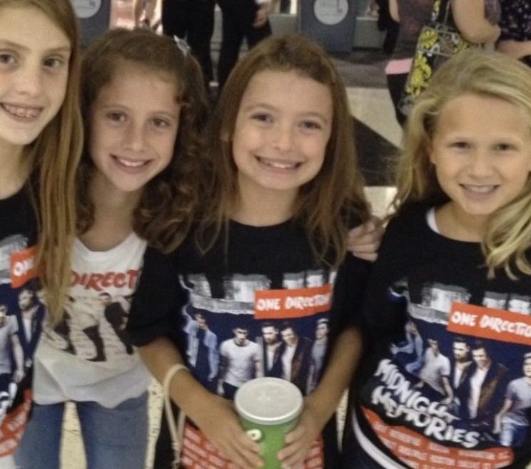 Group picture of 4 young girls (me included) at a One Direction Concert