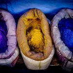 Indigo, turmeric, and lapis pigments in sacks at a market in Morocco