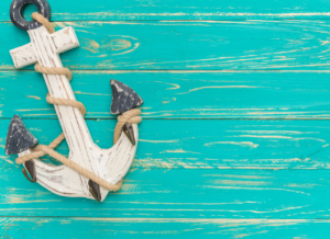 White anchor on distressed wood painted turquoise